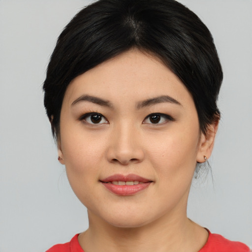 Joyful asian young-adult female with medium  black hair and brown eyes