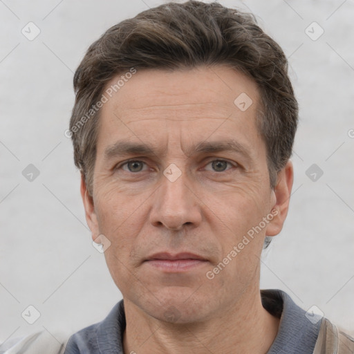 Joyful white adult male with short  brown hair and grey eyes