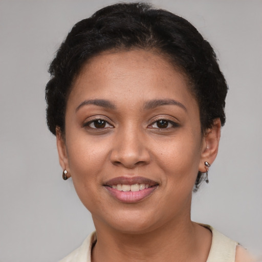 Joyful latino young-adult female with short  brown hair and brown eyes