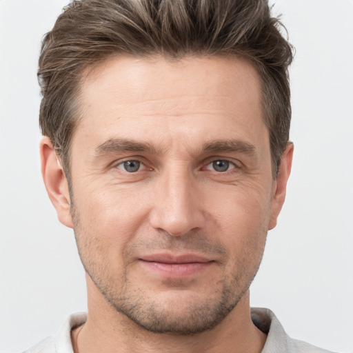 Joyful white adult male with short  brown hair and grey eyes