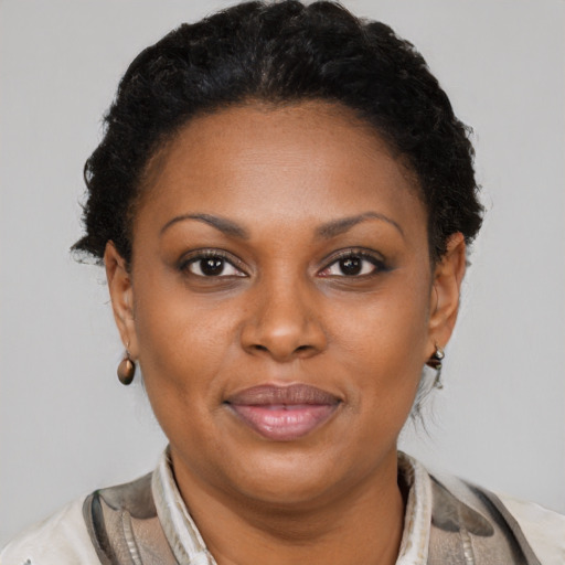 Joyful black adult female with short  brown hair and brown eyes