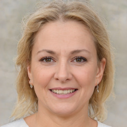 Joyful white adult female with medium  brown hair and brown eyes