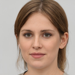 Joyful white young-adult female with medium  brown hair and grey eyes