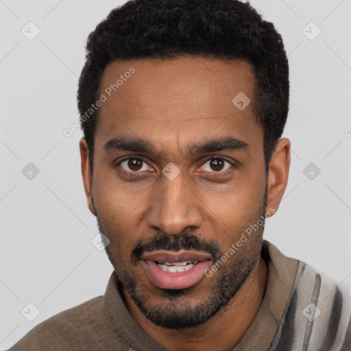 Joyful black young-adult male with short  black hair and brown eyes