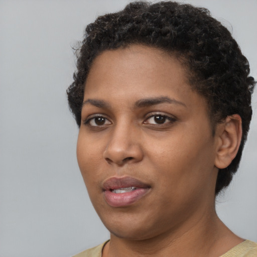 Joyful black young-adult female with short  brown hair and brown eyes