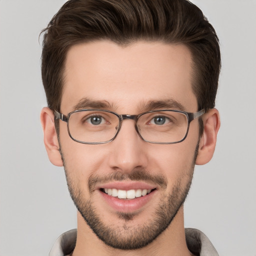 Joyful white young-adult male with short  brown hair and grey eyes