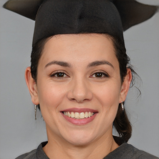 Joyful white young-adult female with medium  black hair and brown eyes