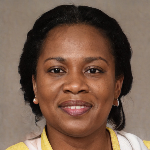 Joyful latino adult female with medium  black hair and brown eyes