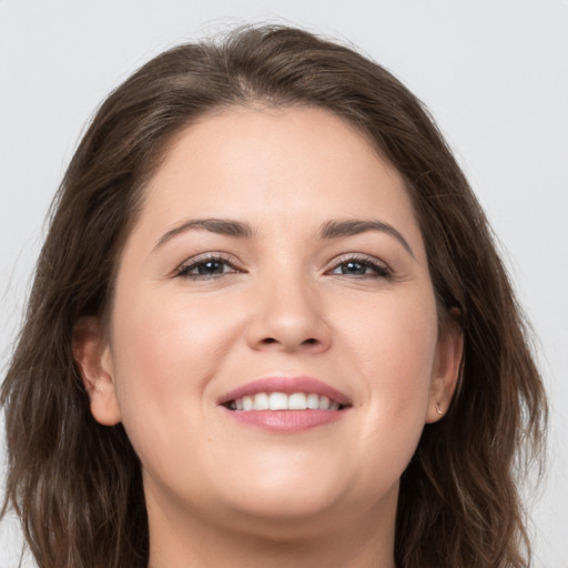 Joyful white young-adult female with long  brown hair and grey eyes