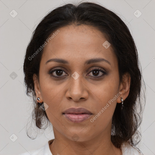 Joyful black adult female with medium  brown hair and brown eyes