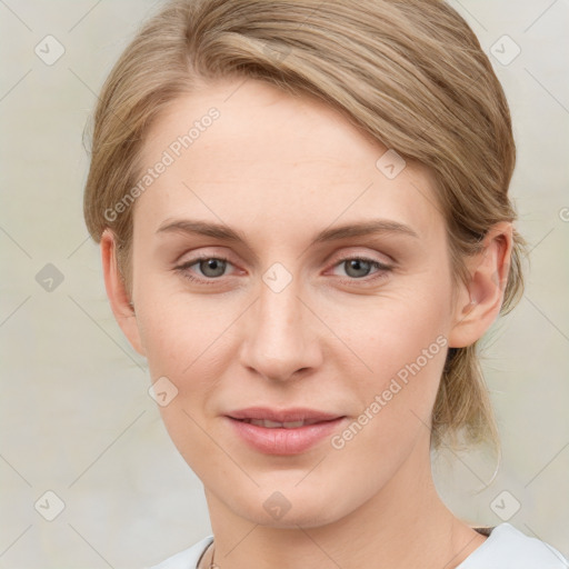 Joyful white young-adult female with medium  brown hair and blue eyes