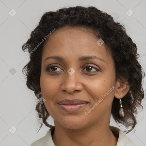 Joyful black adult female with medium  brown hair and brown eyes