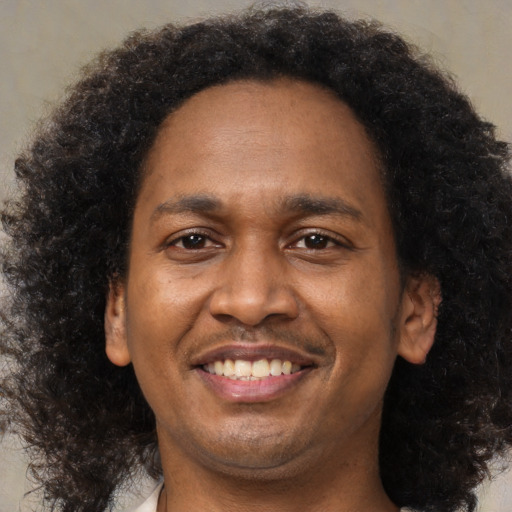 Joyful latino adult male with short  brown hair and brown eyes