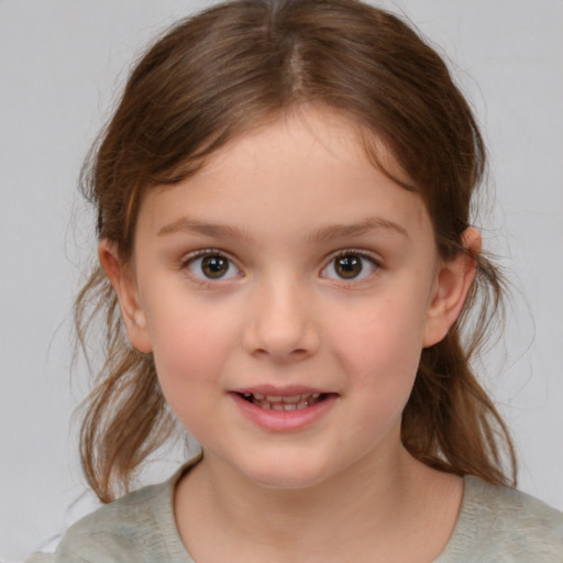 Joyful white child female with medium  brown hair and brown eyes