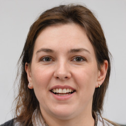 Joyful white young-adult female with medium  brown hair and grey eyes