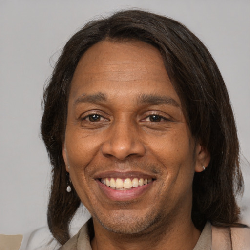 Joyful latino adult male with medium  brown hair and brown eyes