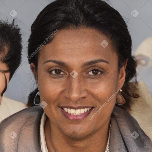 Joyful latino adult female with medium  brown hair and brown eyes