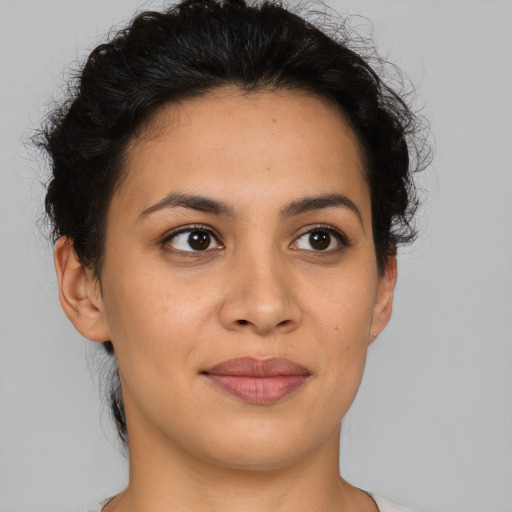 Joyful latino young-adult female with short  brown hair and brown eyes