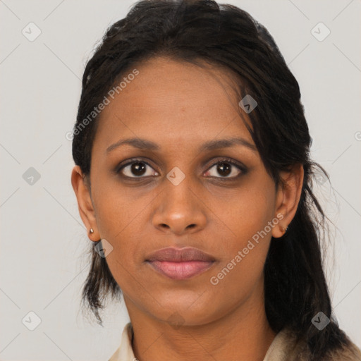 Joyful black young-adult female with long  black hair and brown eyes