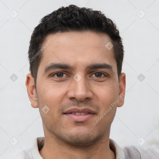 Joyful latino young-adult male with short  brown hair and brown eyes