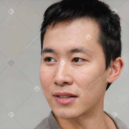 Joyful white young-adult male with short  black hair and brown eyes