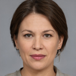 Joyful white adult female with medium  brown hair and grey eyes