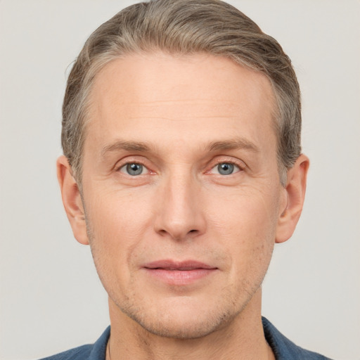 Joyful white adult male with short  brown hair and grey eyes