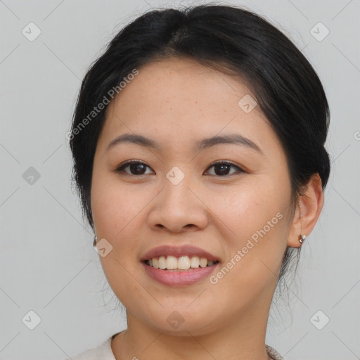 Joyful asian young-adult female with medium  black hair and brown eyes