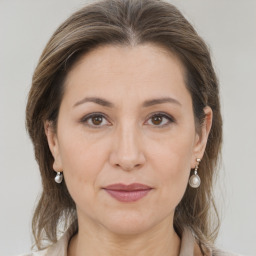 Joyful white adult female with medium  brown hair and brown eyes