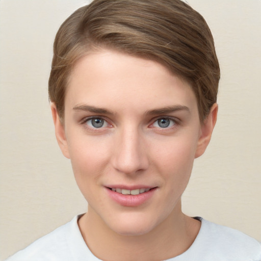 Joyful white young-adult female with short  brown hair and grey eyes