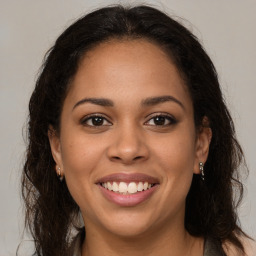 Joyful latino young-adult female with long  brown hair and brown eyes