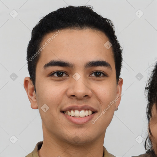 Joyful latino young-adult male with short  brown hair and brown eyes