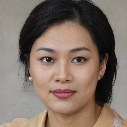 Joyful asian young-adult female with medium  brown hair and brown eyes