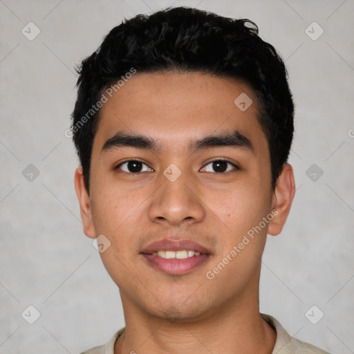 Joyful latino young-adult male with short  black hair and brown eyes