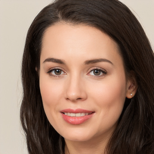 Joyful white young-adult female with long  brown hair and brown eyes