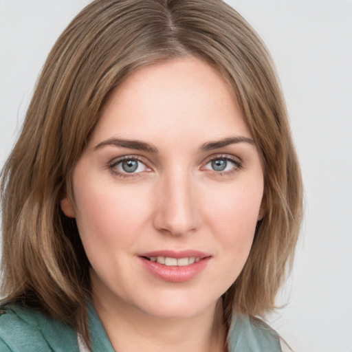 Joyful white young-adult female with medium  brown hair and green eyes