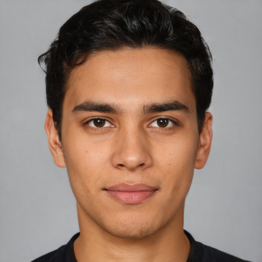 Joyful latino young-adult male with short  black hair and brown eyes