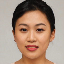 Joyful asian young-adult female with short  brown hair and brown eyes