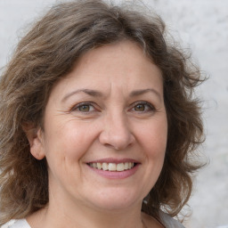 Joyful white adult female with medium  brown hair and grey eyes