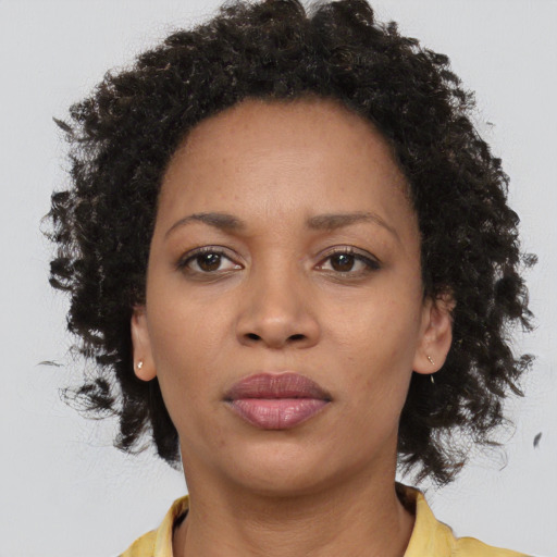 Neutral black young-adult female with medium  brown hair and brown eyes