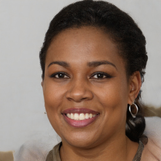 Joyful black young-adult female with medium  brown hair and brown eyes