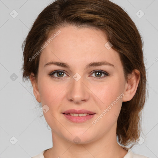 Joyful white young-adult female with medium  brown hair and green eyes