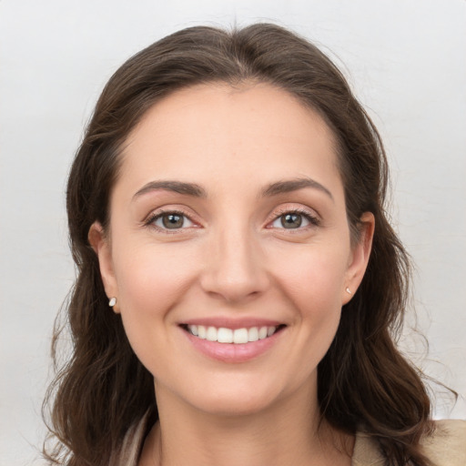 Joyful white young-adult female with long  brown hair and grey eyes