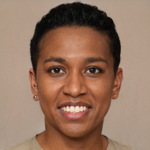 Joyful black young-adult female with short  black hair and brown eyes