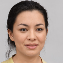 Joyful asian young-adult female with medium  brown hair and brown eyes