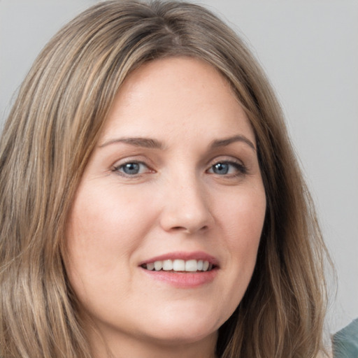 Joyful white young-adult female with long  brown hair and grey eyes