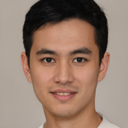 Joyful latino young-adult male with short  brown hair and brown eyes