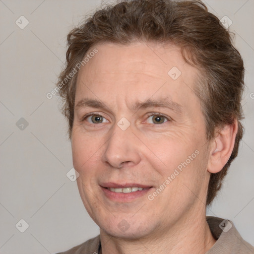 Joyful white adult male with short  brown hair and grey eyes