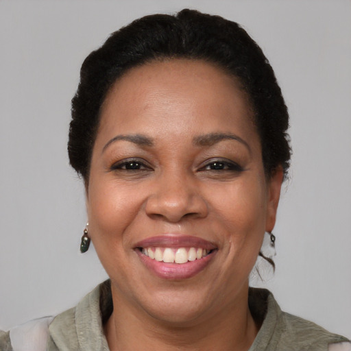 Joyful latino adult female with short  black hair and brown eyes