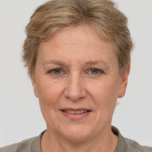 Joyful white middle-aged female with short  brown hair and grey eyes